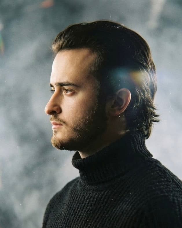 Mesrop Simonyan, founder of Apella, in profile in a black turtleneck